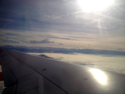 Awkwardly asked my neighbour on the plane to take a photo for me. Snowy mountains - 4 weeks until ski time!